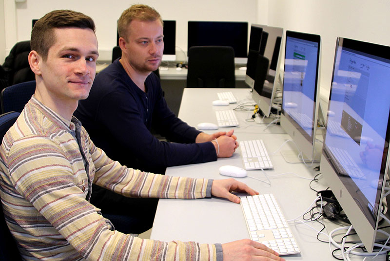 Zwei Männer sitzen im Mac-Labor der FH Kiel.