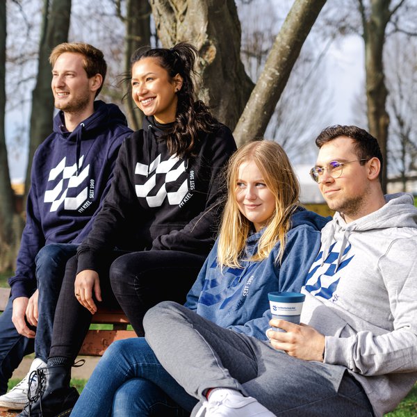 vier junge Menschen auf einer Bank