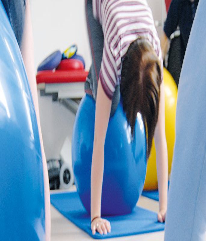 Students exercising with a sitting ball