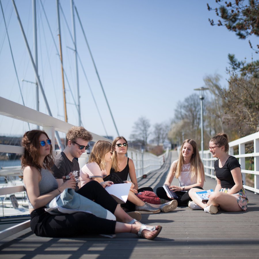 Studierende auf einer Brücke