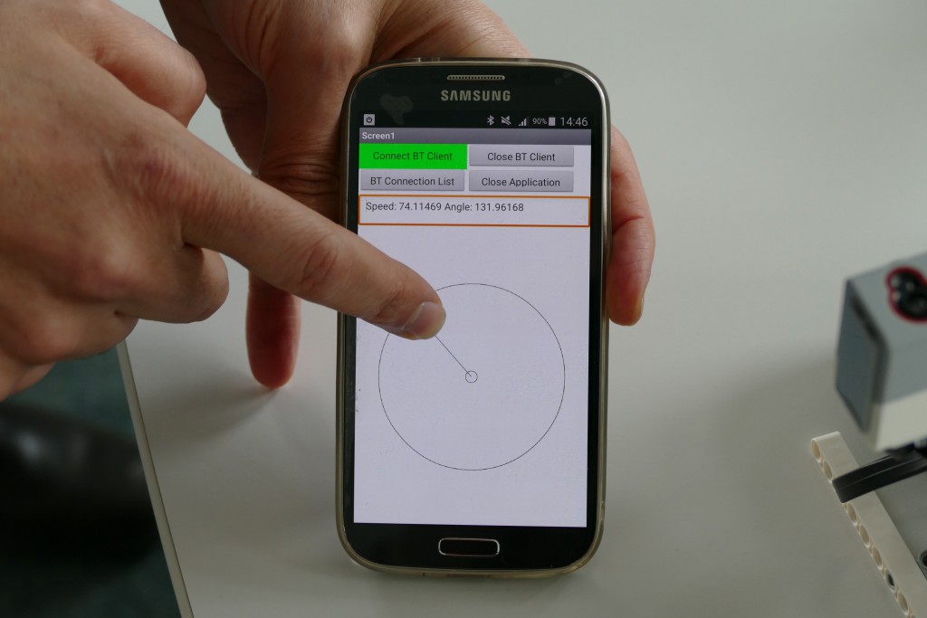 Eine Hand hält ein Smartphone, die andee tippt auf dessen Touchpad. Es ist eine App geöffnet, die einen Kreis und den dazugehörigen Radius anzeigt.